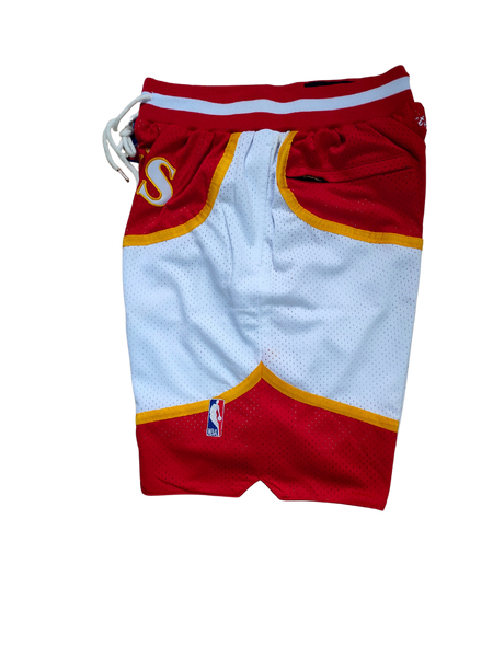 Retro NBA basketball shorts with bold team logos and vintage design, featuring elastic waistbands and detailed stitching
