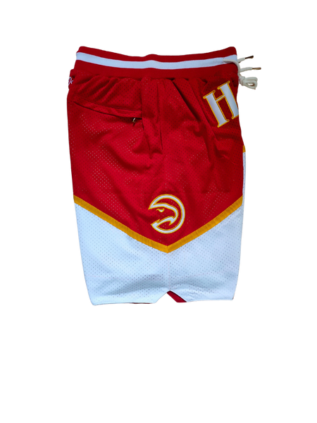 Retro NBA basketball shorts with bold team logos and vintage design, featuring elastic waistbands and detailed stitching